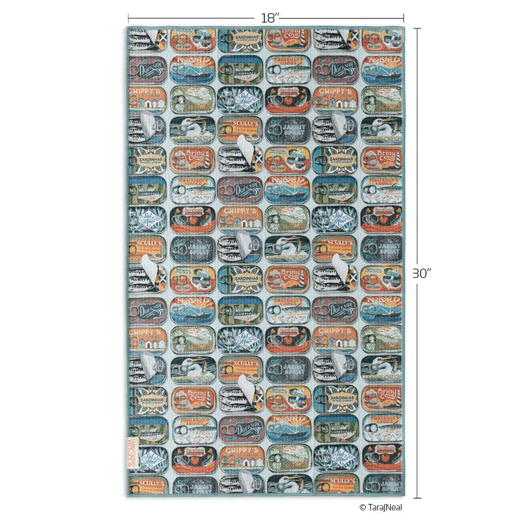 Microfiber towel with a repeating pattern of colorful, vintage-style sardine tin labels on a light blue background.
