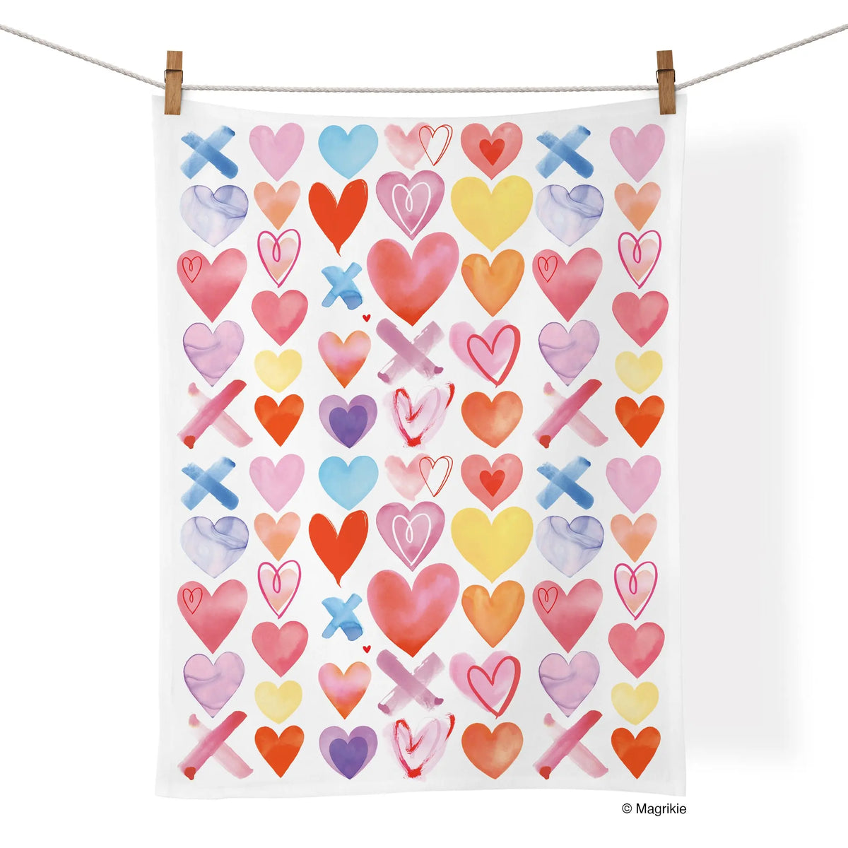 White cotton kitchen towel featuring a colorful, repeating watercolor pattern of hearts and X shapes.