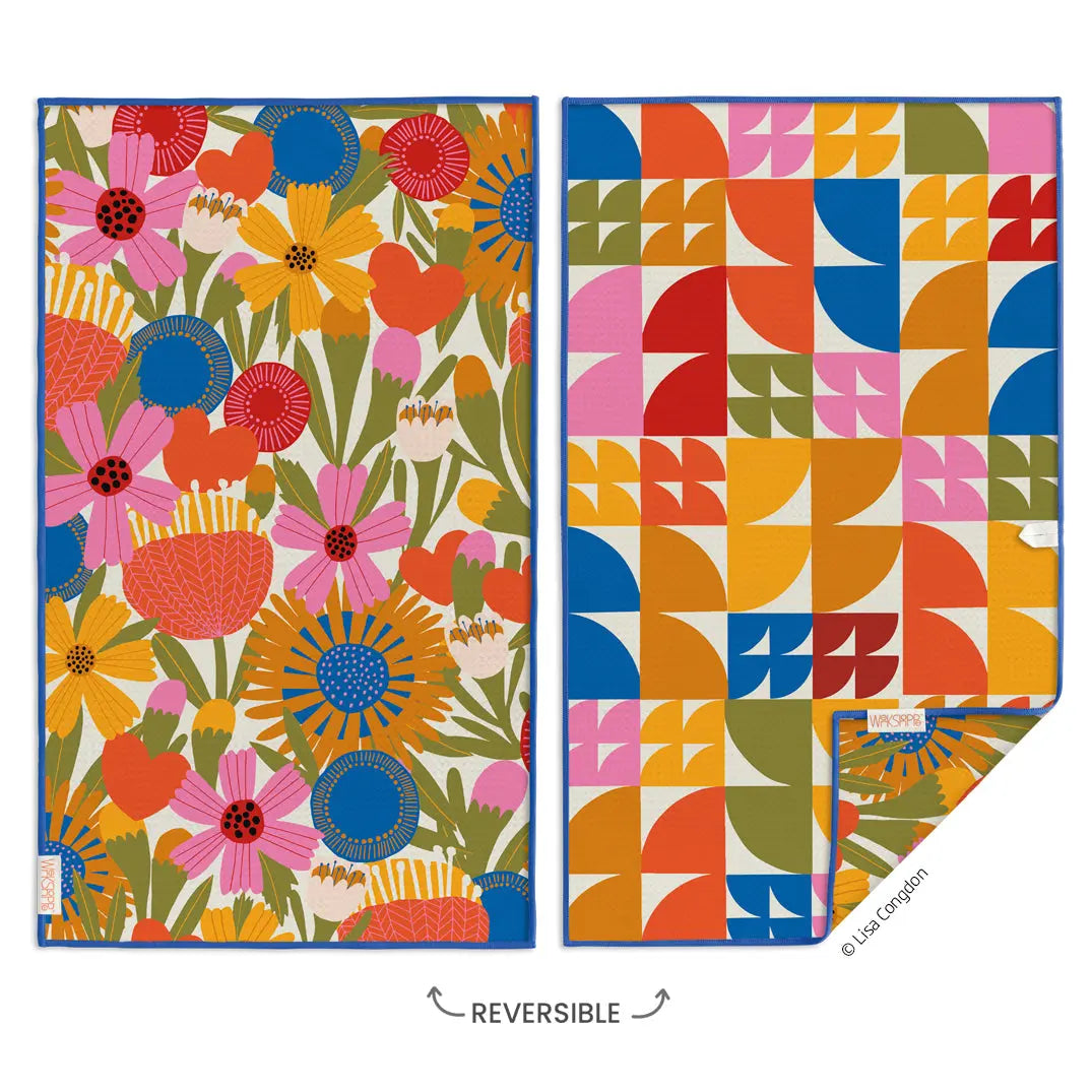 Reversible microfiber kitchen towel with a vibrant floral pattern on one side and colorful geometric shapes on back.