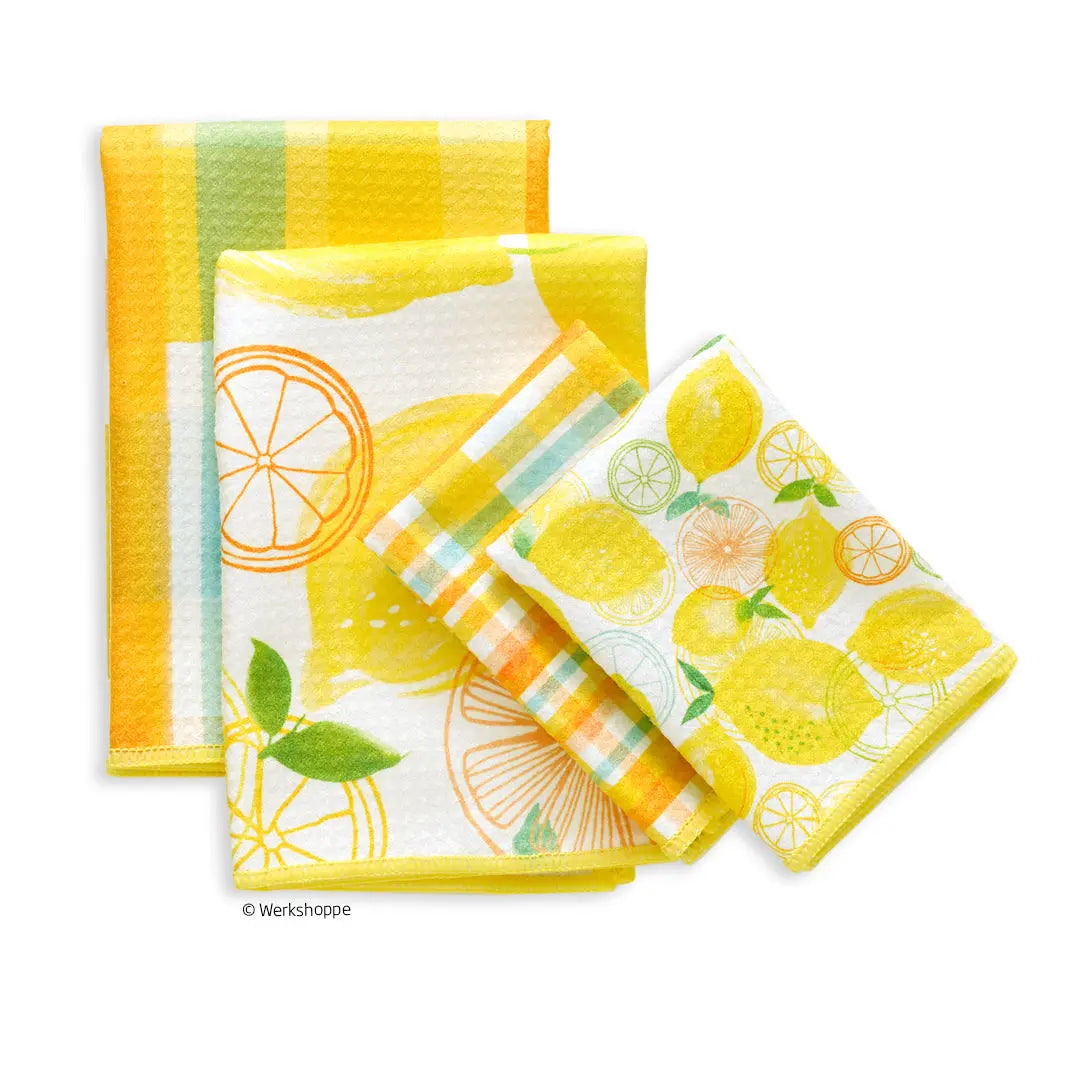Set of three kitchen towels featuring yellow lemon illustrations, checkered plaid patterns, and white textured fabric.