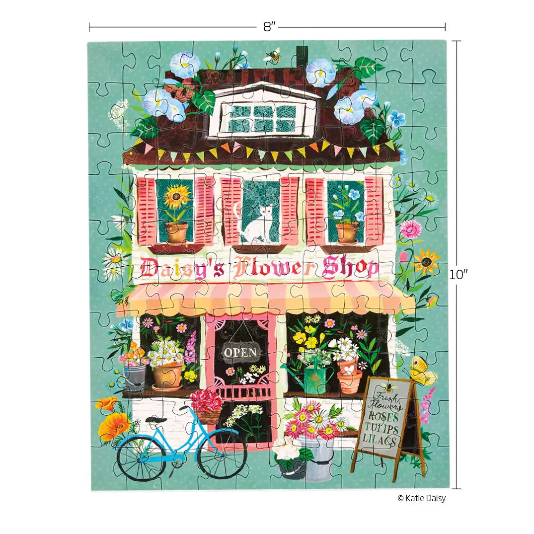 A 100-piece puzzle showing a whimsical, illustrated flower shop with a blue bicycle, flowers, and a cat in a window.