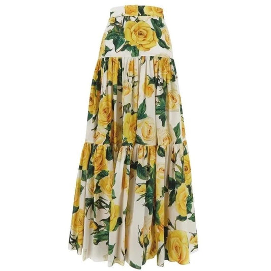 Floral maxi skirt with yellow roses on a white background, featuring a tiered design and flowy fabric.