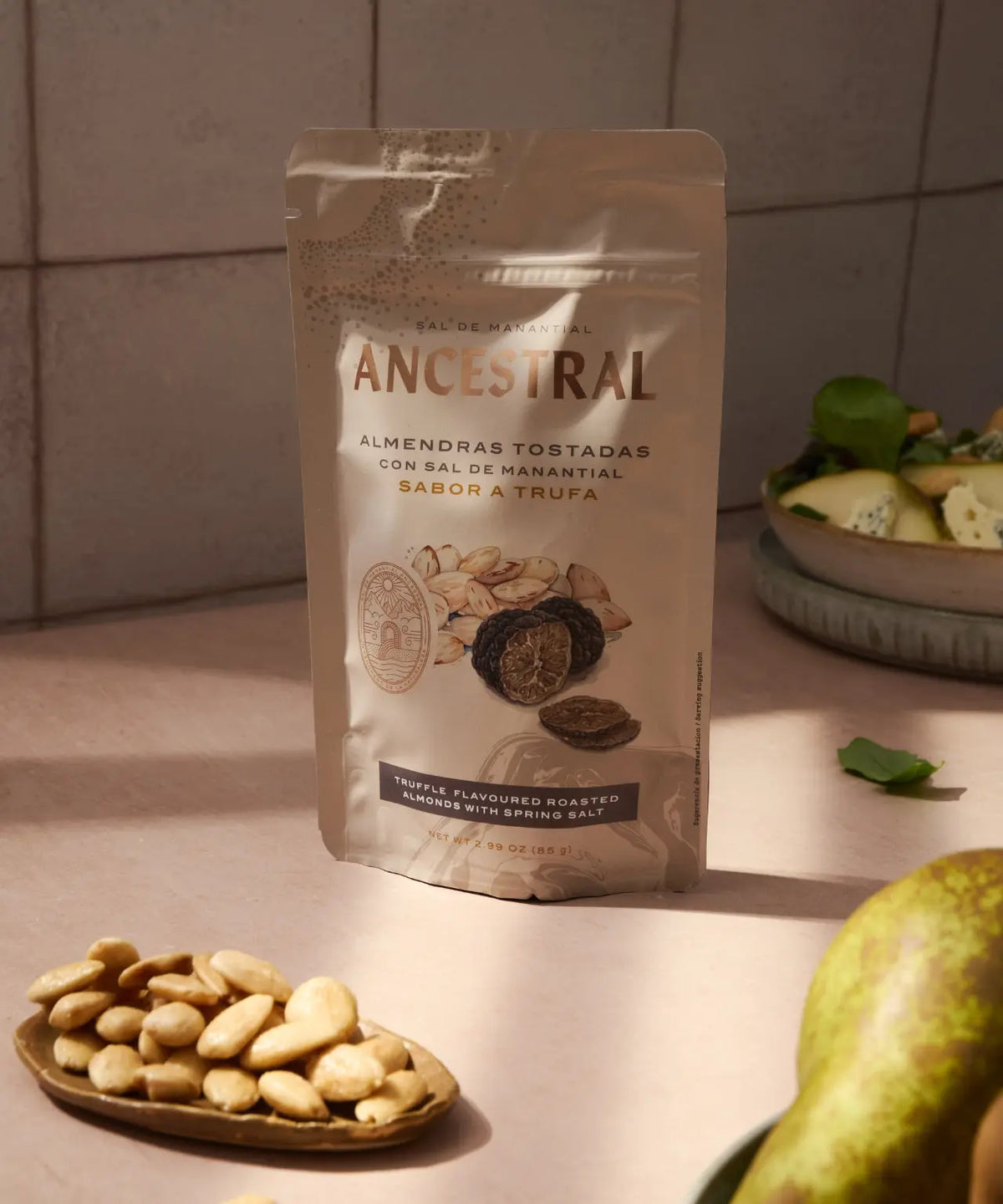 Beige snack pouch of Ancestral truffle-flavored roasted almonds with spring salt, featuring illustrated ingredients.