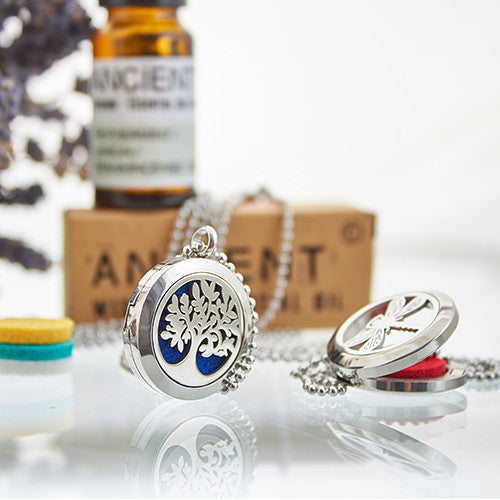 Silver tree of life locket necklace with blue enamel, featuring a vibrant interior and a delicate ball chain.
