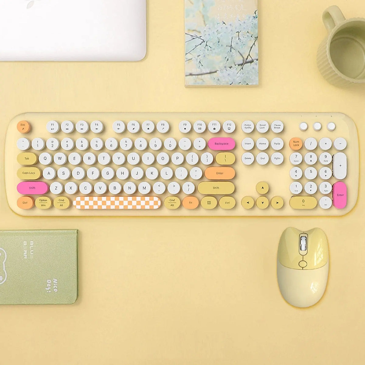 Colorful wireless keyboard with round keys, checkered spacebar, and a matching cream-yellow silent mouse on a desk.
