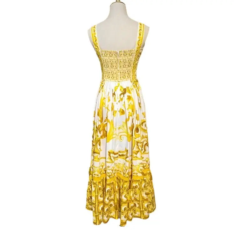 Elegant white and yellow floral maxi dress with a smocked back and ruffled hem, perfect for summer occasions.