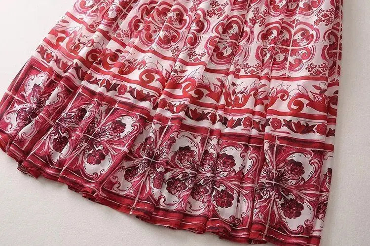 Red and white floral patterned maxi skirt, featuring intricate designs and flowing fabric. Perfect for summer outings.