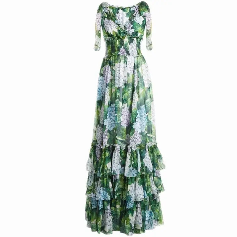 Floral maxi dress with green, blue, and purple hues, featuring ruffled tiers and a smocked bodice. Perfect for summer.