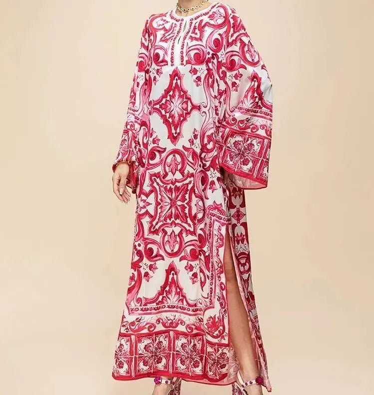 Red and white printed maxi dress with long sleeves and side slits, perfect for summer occasions.
