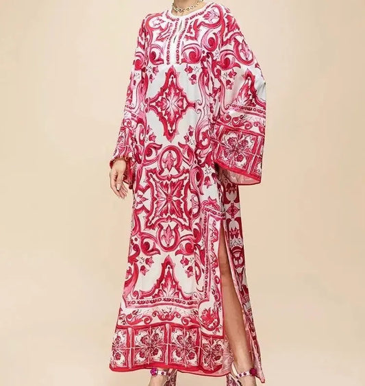 Red and white printed maxi dress with long sleeves and side slits, perfect for summer occasions.