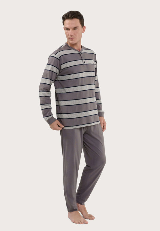 Hombre con pijama largo de punto: camiseta de rayas grises con tapeta de botones y pantalón liso gris oscuro.
