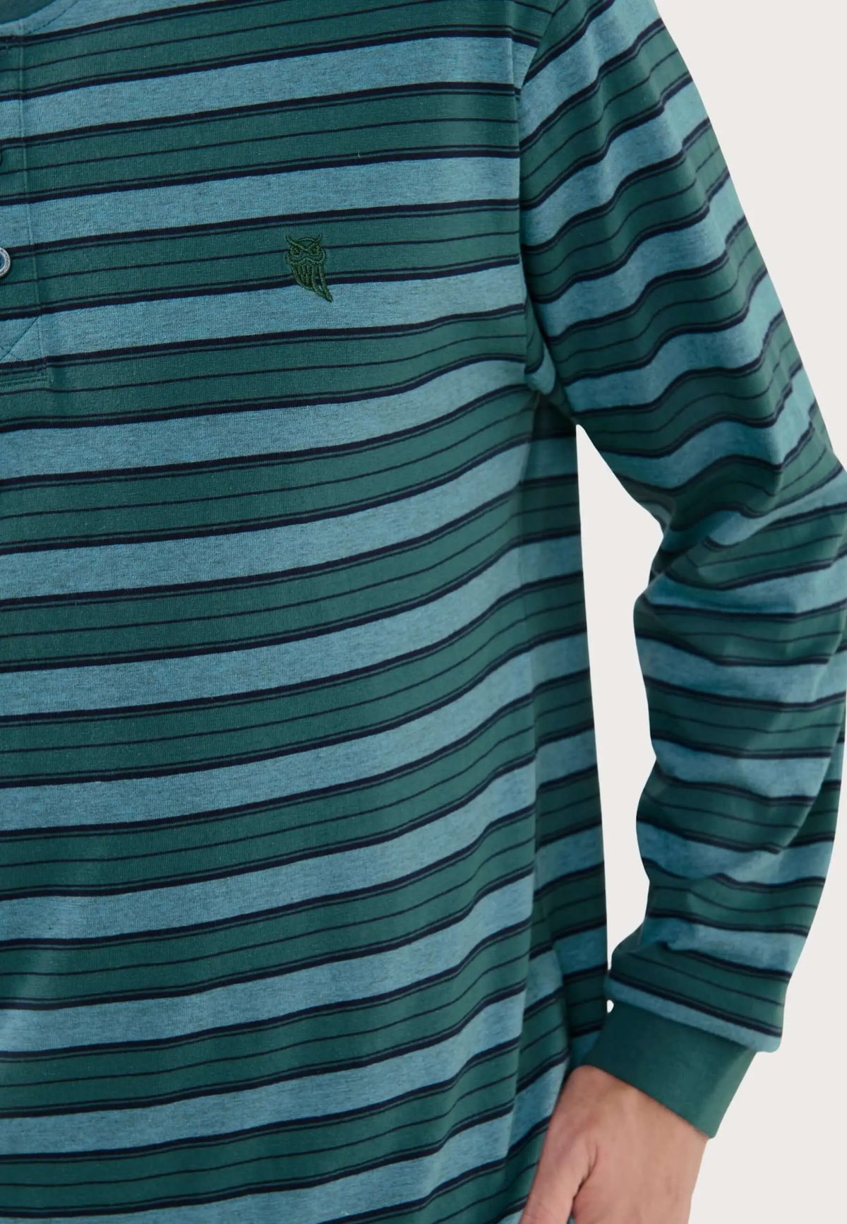Pijama de hombre a rayas verdes y azules con tapeta de botones, cuello y logo de búho bordado en tejido de punto.