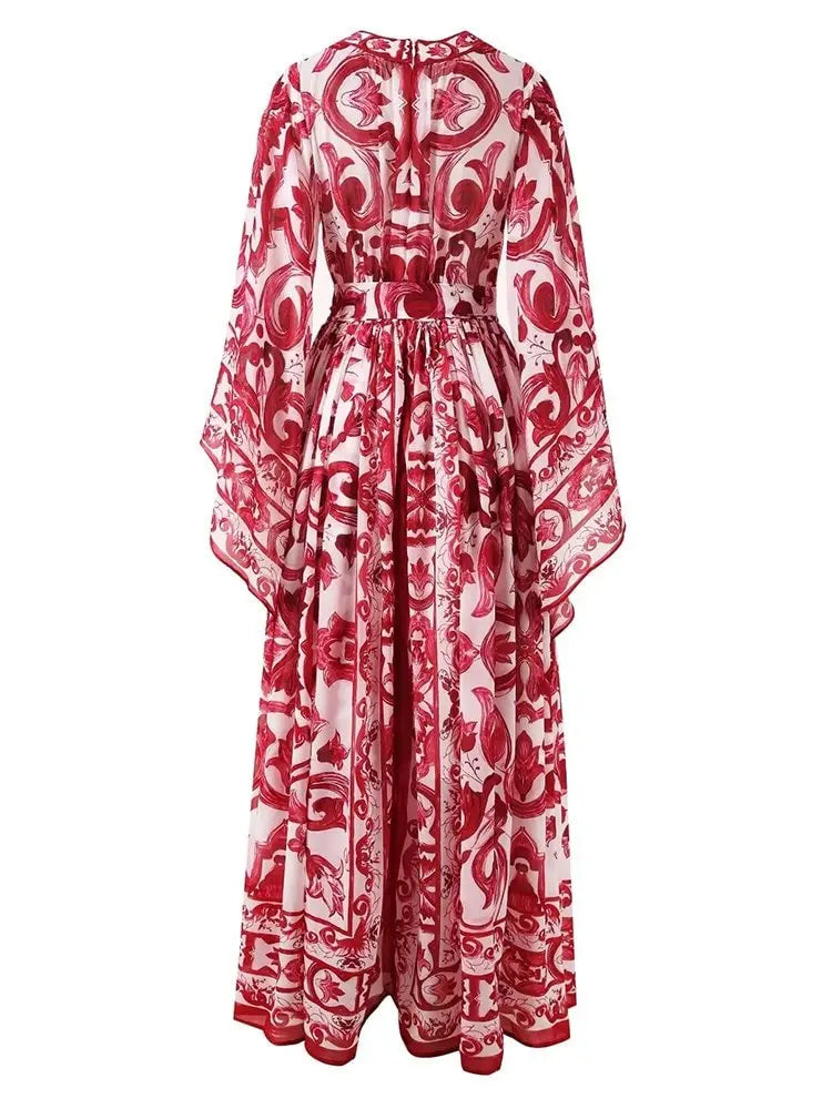 Red and white floral print maxi dress with long sleeves and a cinched waist, crafted from lightweight fabric.