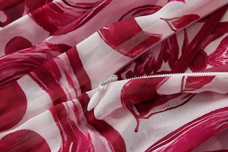 Red and pink floral patterned lightweight fabric with a white zipper detail. Ideal for summer clothing.