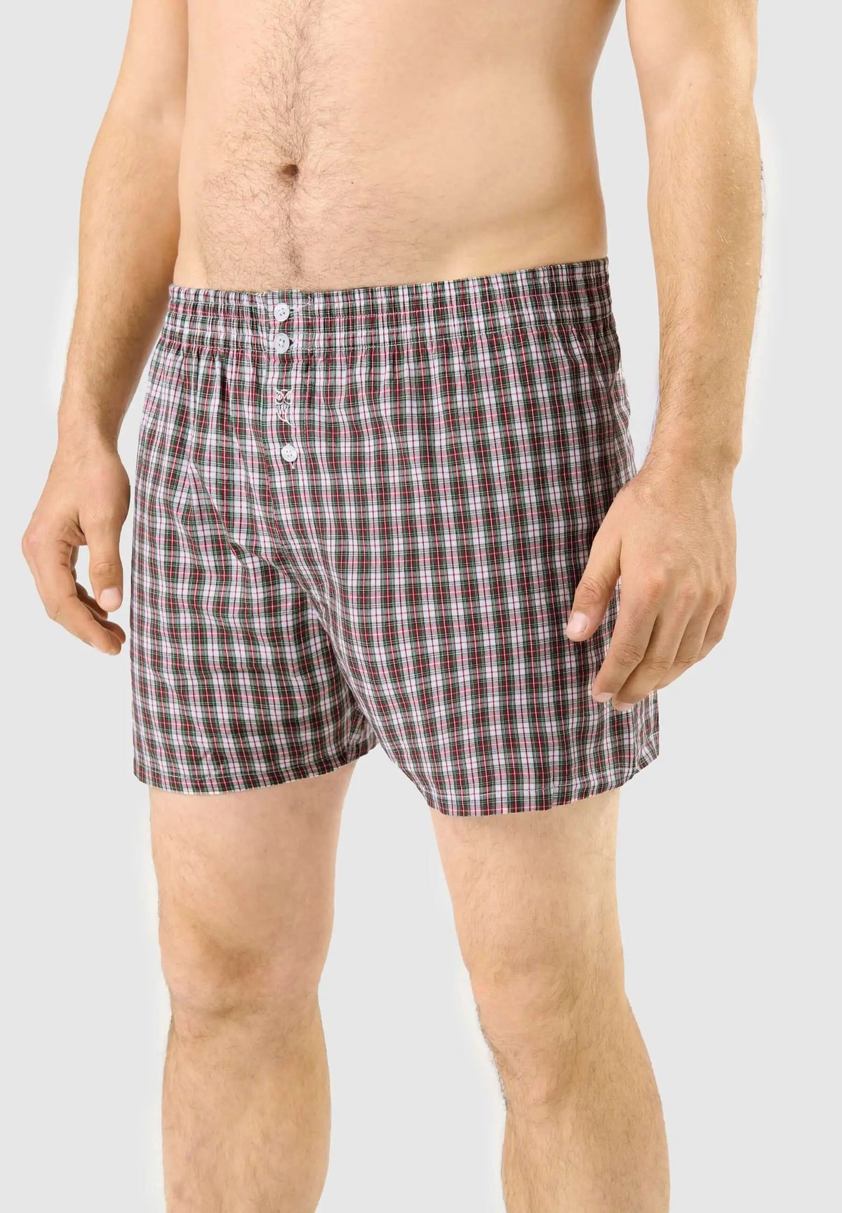 Calzoncillo bóxer de hombre en algodón con estampado de cuadros verdes, blancos y rojos, ajuste holgado y botones.