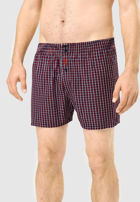 Calzoncillo bóxer de hombre en algodón con estampado de cuadros rojos y azules, ajuste holgado y cierre de botones.