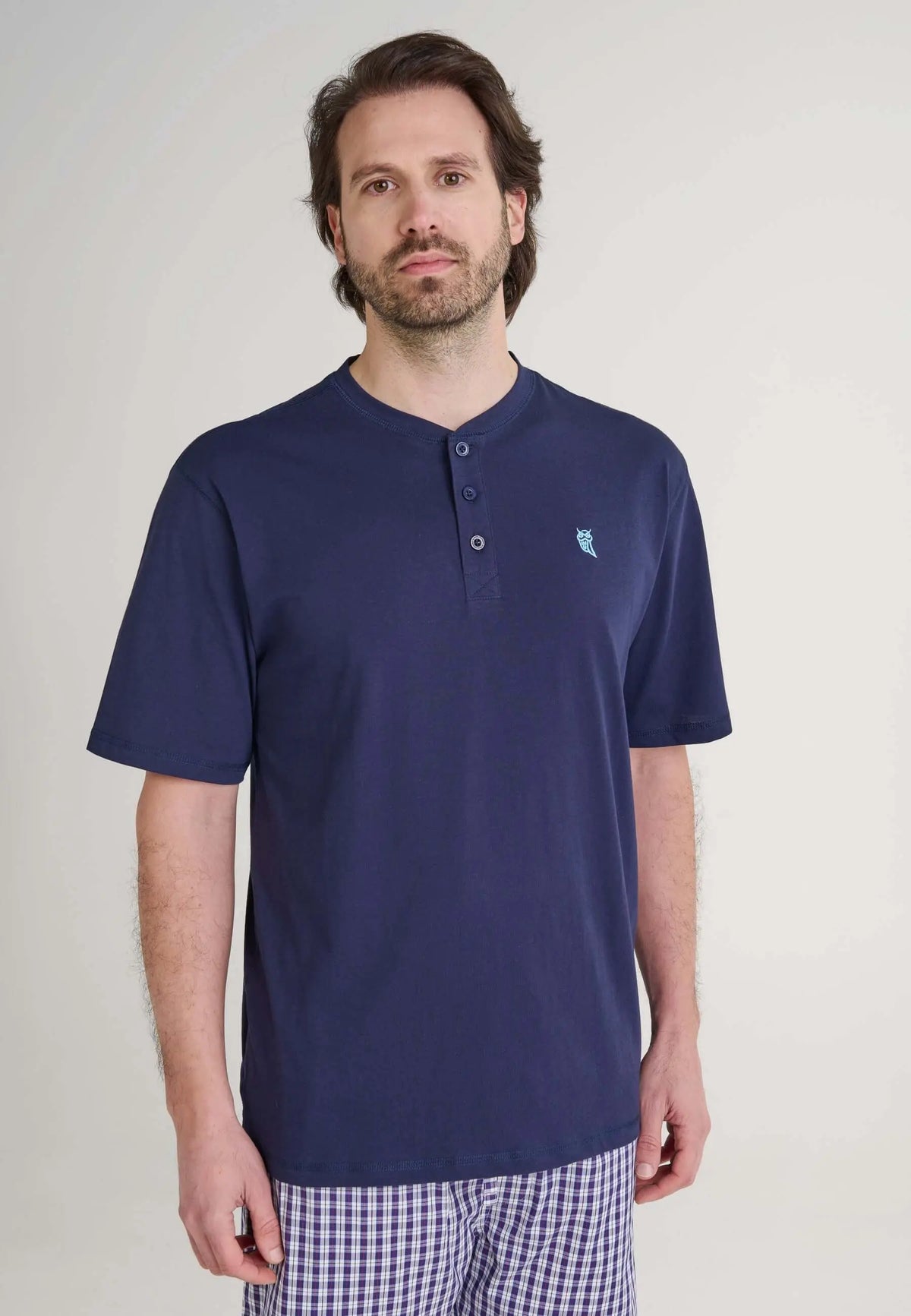 Camiseta de pijama azul para hombre, manga corta y cuello con tapeta de botones, hecha en algodón de ajuste cómodo.