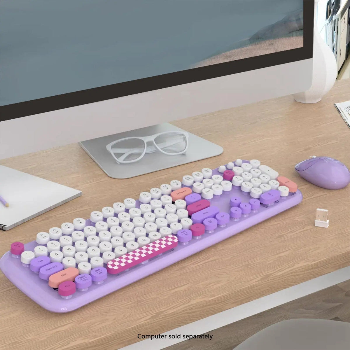 Purple wireless keyboard and mouse set with round white keys, accented by pink, violet, and checkered spacebar.