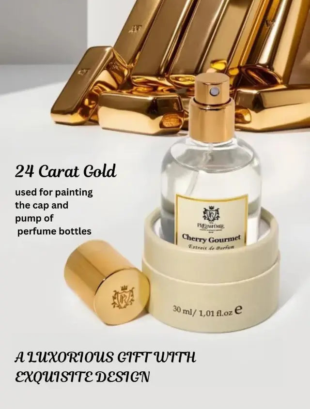 Cherry Gourmet perfume bottle with a 24-carat gold cap and pump, displayed with a cream-colored cylindrical base.