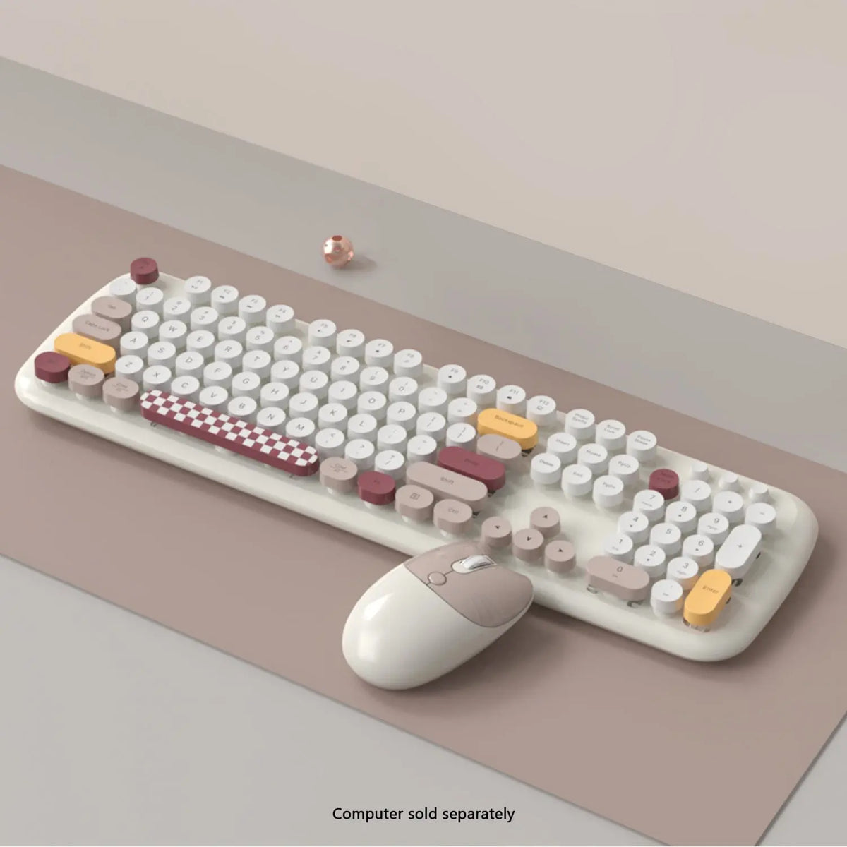 Wireless keyboard and mouse with round keys in white, tan, and checkered patterns on a neutral beige desk surface.