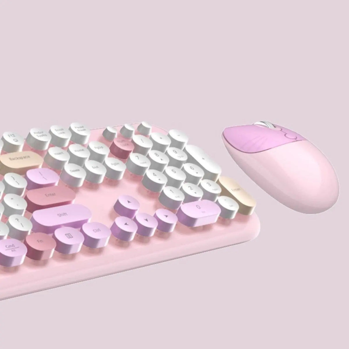 Wireless keyboard and mouse combo in pastel pink and white with rounded, typewriter-style keys on a soft pink base.