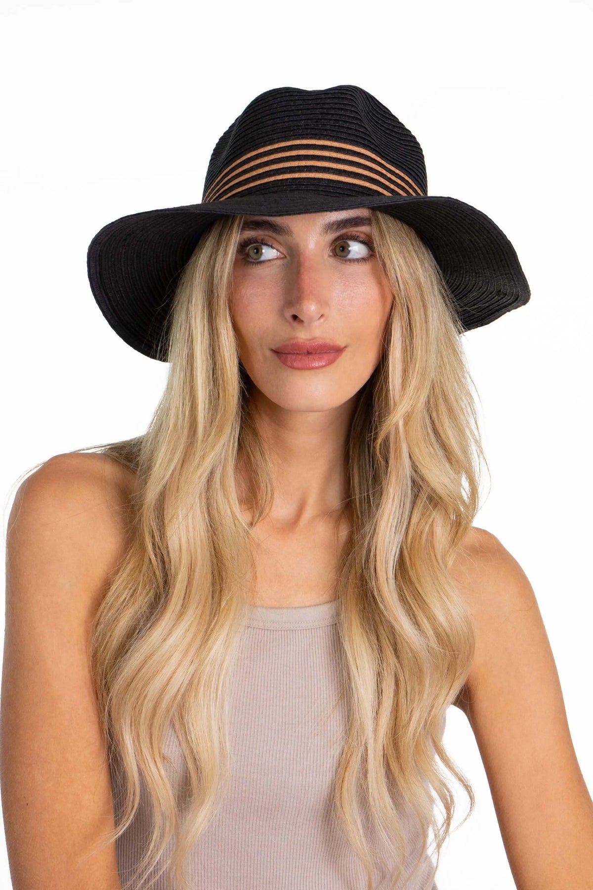 Black straw Panama hat featuring a pinched crown with tan striped detailing worn by a woman with long blonde hair.