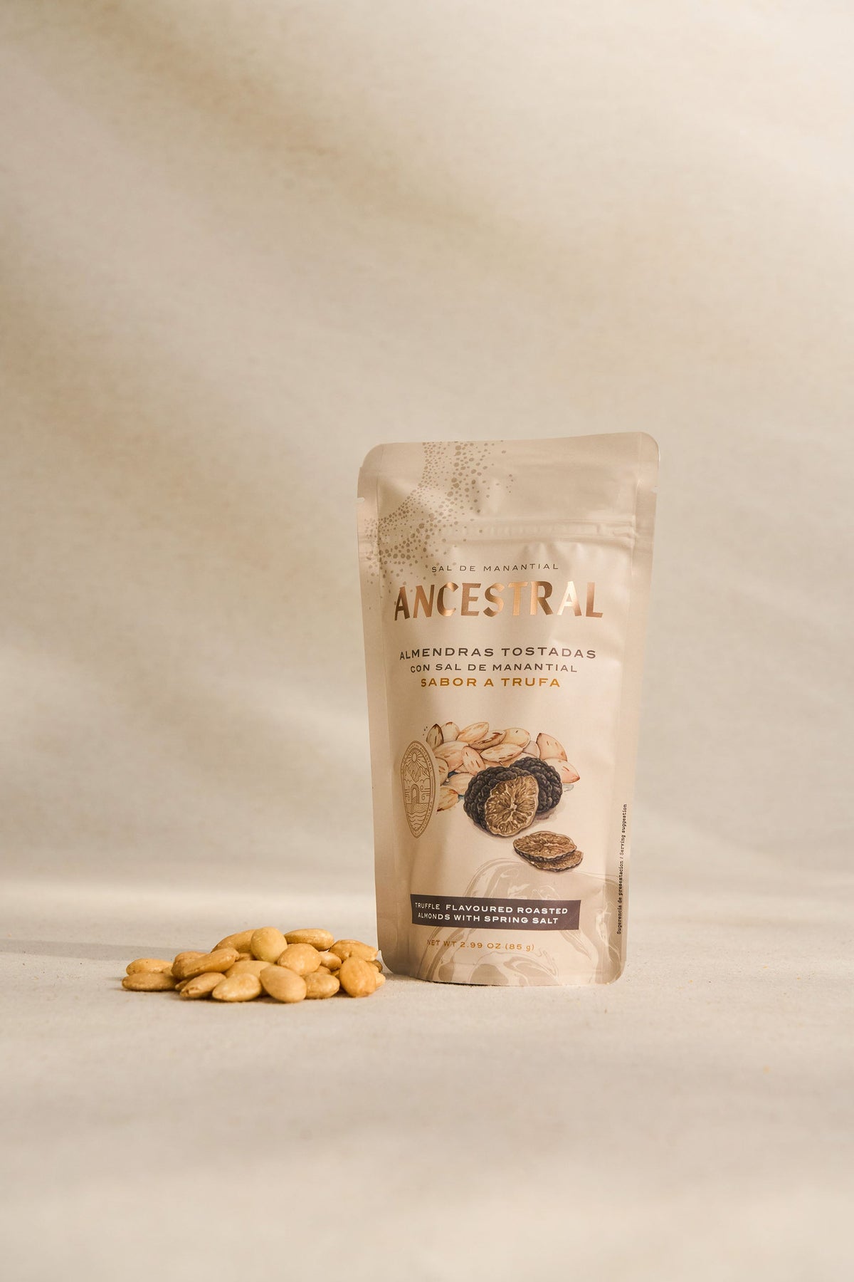 Pouch of truffle-flavored roasted almonds with spring salt, featuring a beige minimalist design on a neutral background.