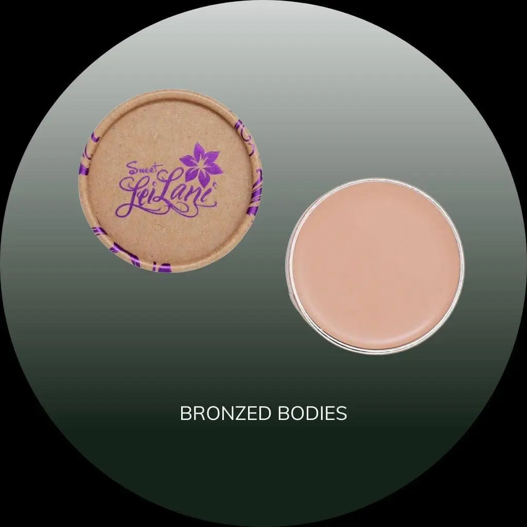 Sweet LeiLani foundation and concealer in a circular compact with a tan lid, next to the light brown cream product.