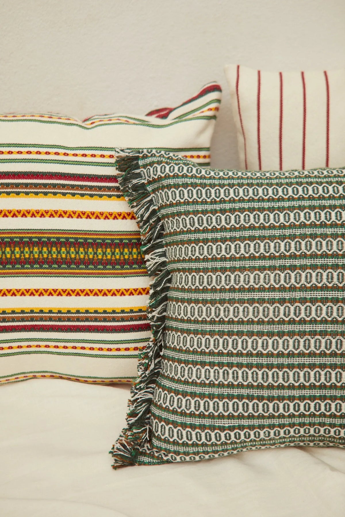 Square green cushion cover with a retro bird's-eye pattern and fringe trim, 45x45cm, textured fabric.