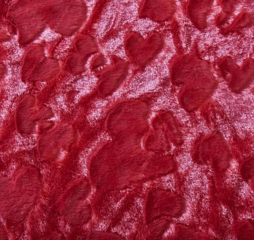 Candy apple red faux fur throw pillow cover featuring a textured, embossed heart pattern with a soft, plush feel.