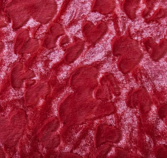 Candy apple red faux fur throw pillow cover featuring a textured, embossed heart pattern with a soft, plush feel.