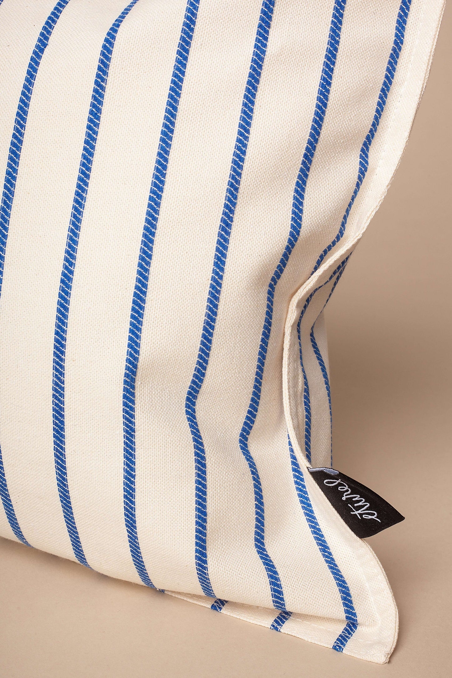 Rectangular off-white cushion cover with vertical blue striped pattern in a textured, canvas-like fabric.