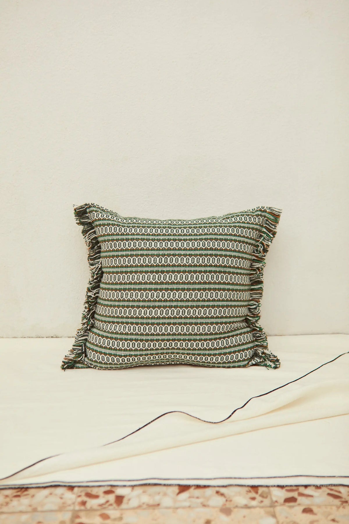 Square green retro-style cushion cover with a bird's-eye pattern and frayed edges, measuring 45cm x 45cm.