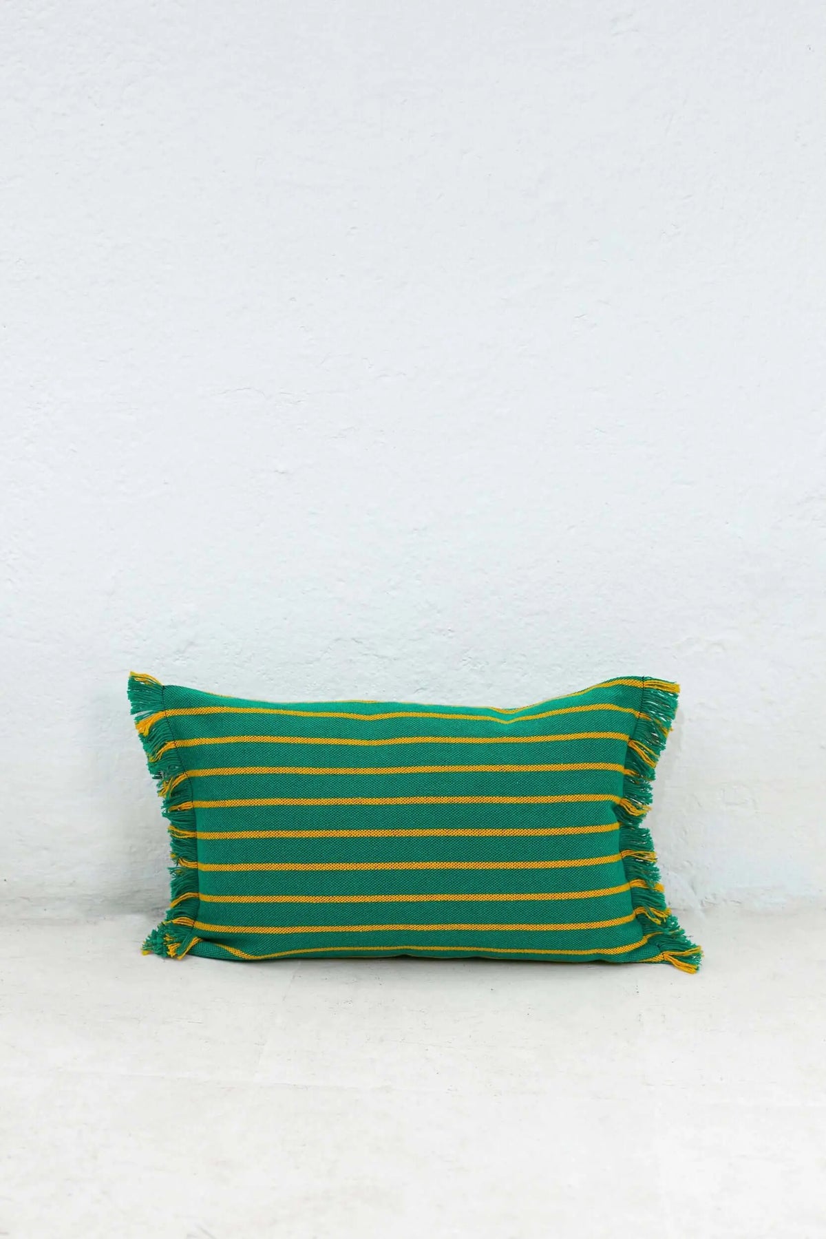 Rectangular 30x45cm cushion cover, green fabric with thin yellow horizontal stripes and fringed edges.