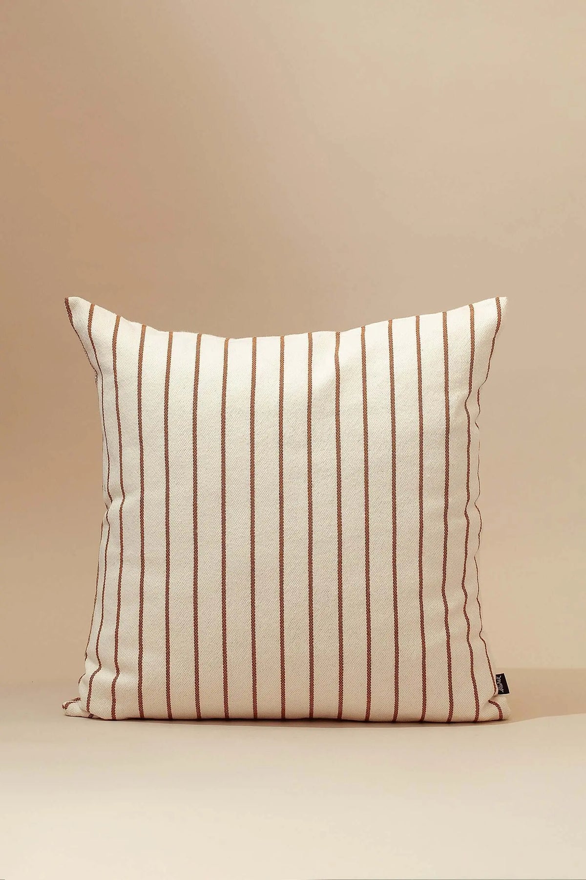 Square cushion cover made of beige canvas with thin vertical caramel-brown stripes against a neutral background.