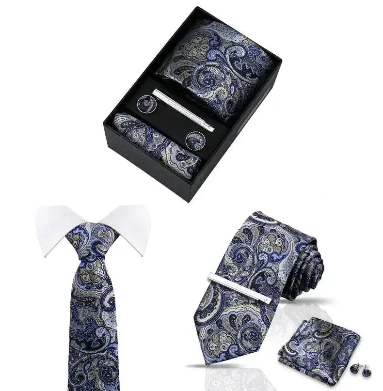 Conjunto corbata paisley azul y platino con pañuelo, gemelos y pasador en una elegante caja. Diseñado para ocasiones especiales.