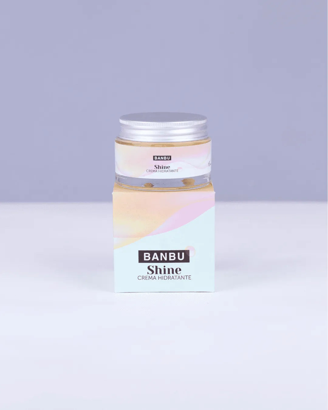 Tarro de cristal con tapa metálica y caja de cartón de la crema hidratante Shine de Banbu, en tonos pastel suaves.