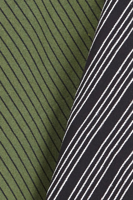 Dos paños de cocina de loneta con diseño de rayas diagonales, uno en verde oliva y otro en negro con líneas blancas.