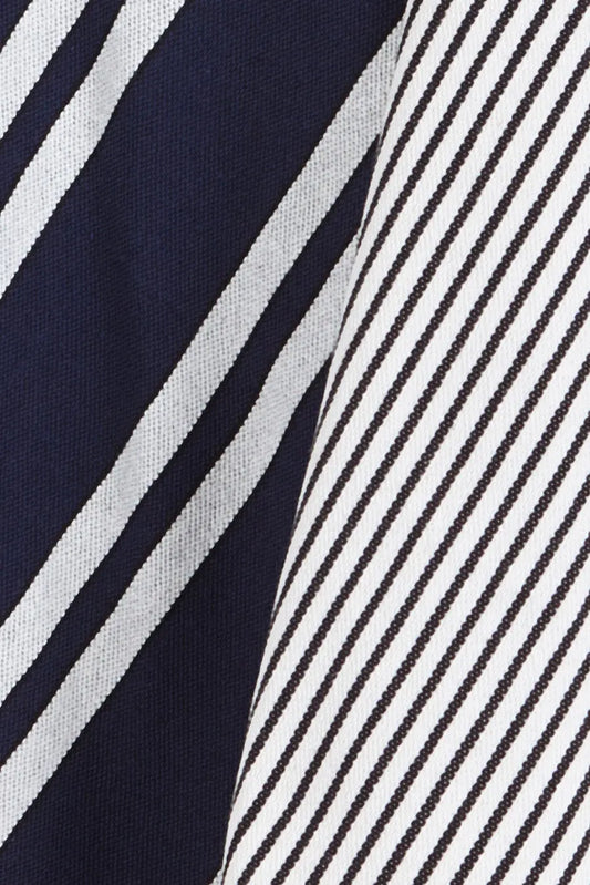 Two dish towels featuring blue and white diagonal stripes in both wide and thin variations on textured fabric.
