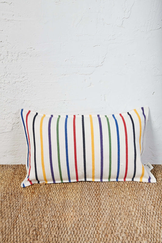 Rectangular cushion in off-white woven fabric with colorful vertical stripes of yellow, red, blue, green, and black.