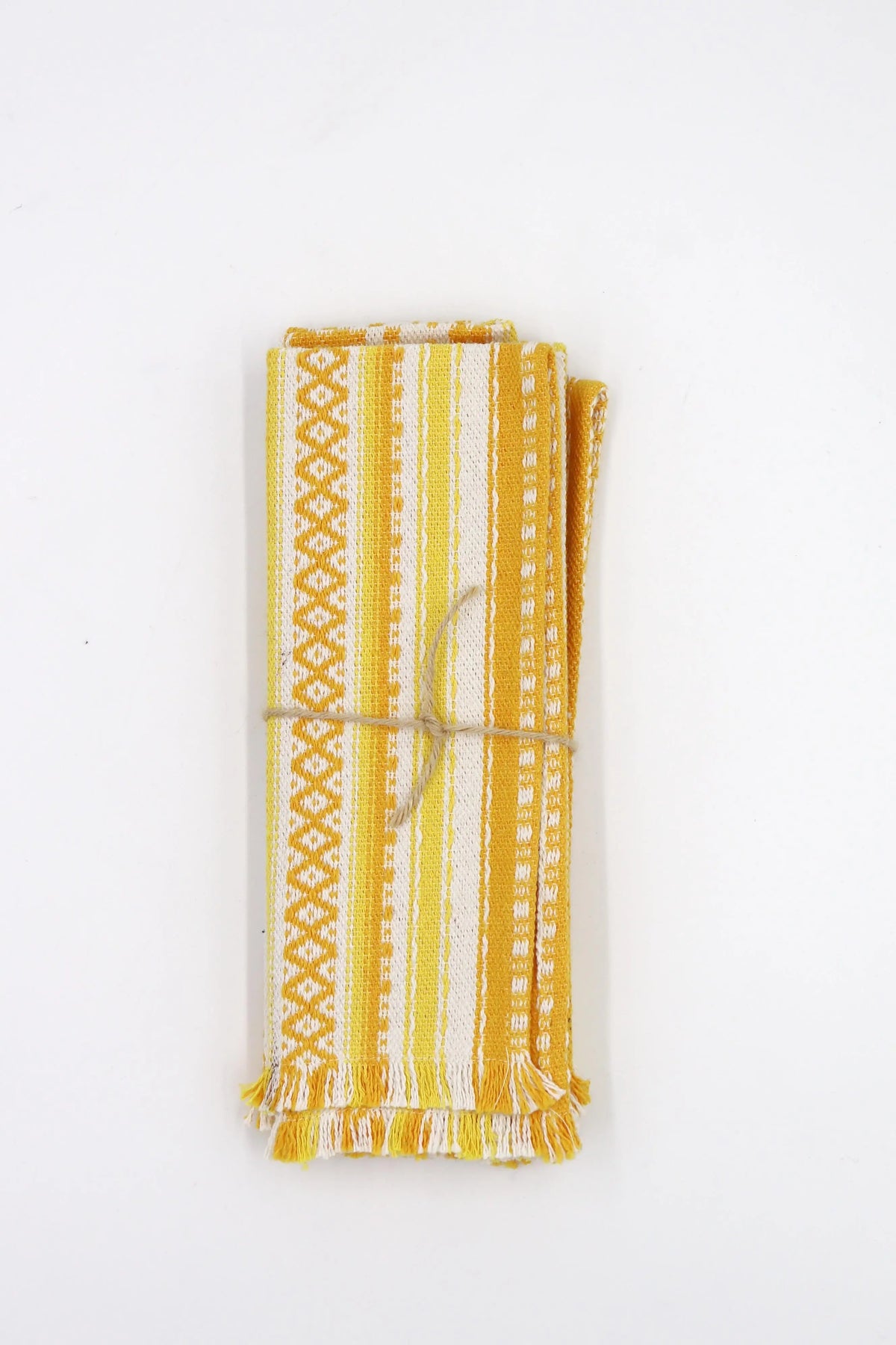 Two yellow and white woven fabric placemats with striped geometric patterns and fringed edges, tied with twine.