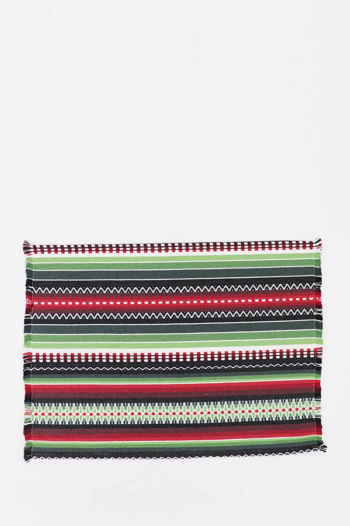 Rectangular woven placemat with a striped, multicolored pattern in green, red, black, and white with fringed edges.
