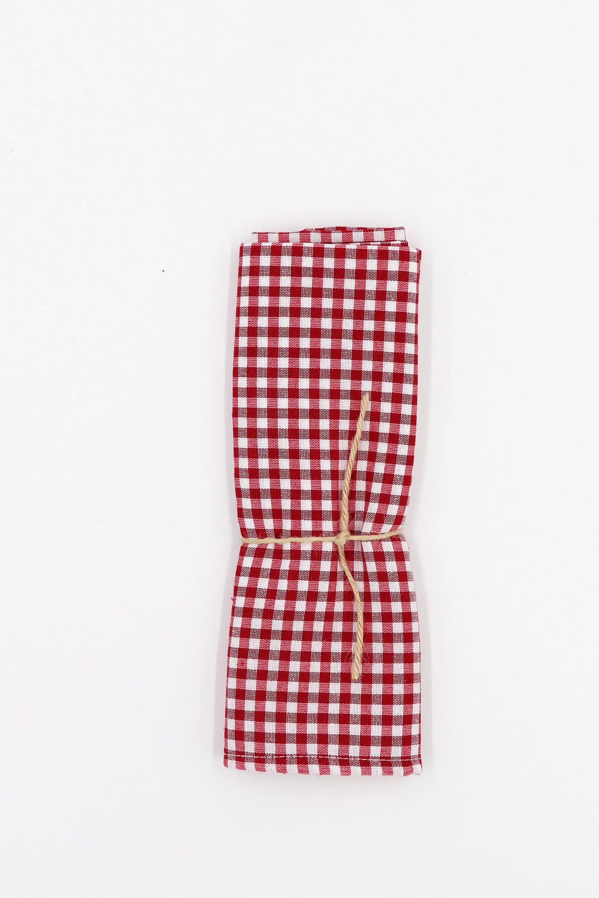 Two red and white gingham fabric napkins tied together with a rustic twine string against a white background.