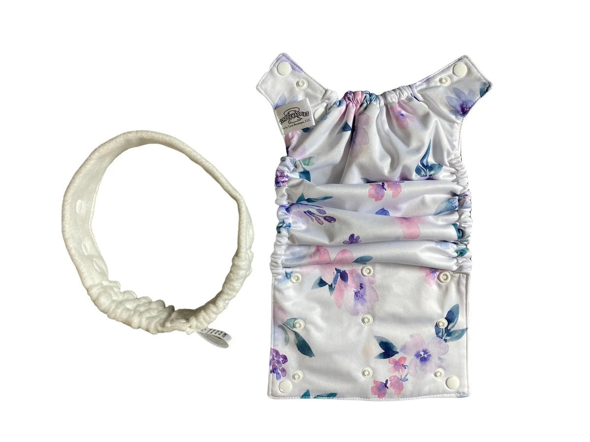 Floral printed PUL all-in-two diaper cover with snaps and a matching white elastic headband on a white background.