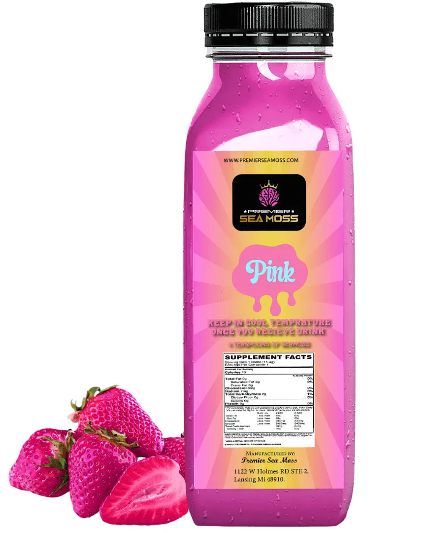 A 12 oz bottle of pink sea moss lemonade with a sunburst label, next to a small pile of fresh red strawberries.