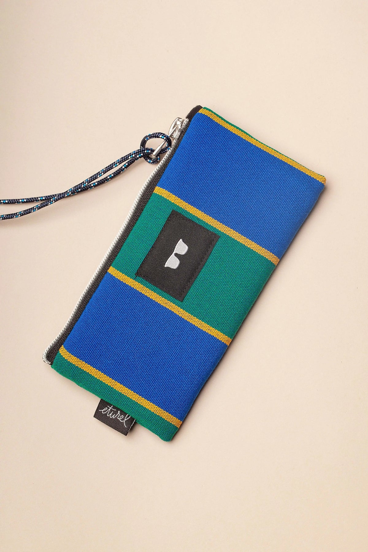 Blue and green striped canvas sunglasses pouch with a zipper closure and a rope wrist strap.