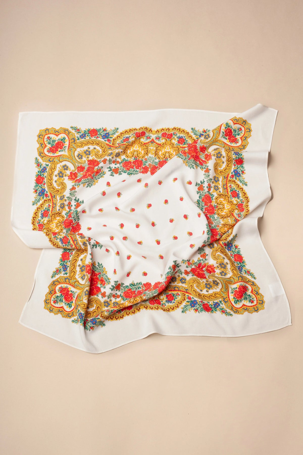 White square scarf featuring a colorful floral and gold chain pattern with scattered red rosebuds.