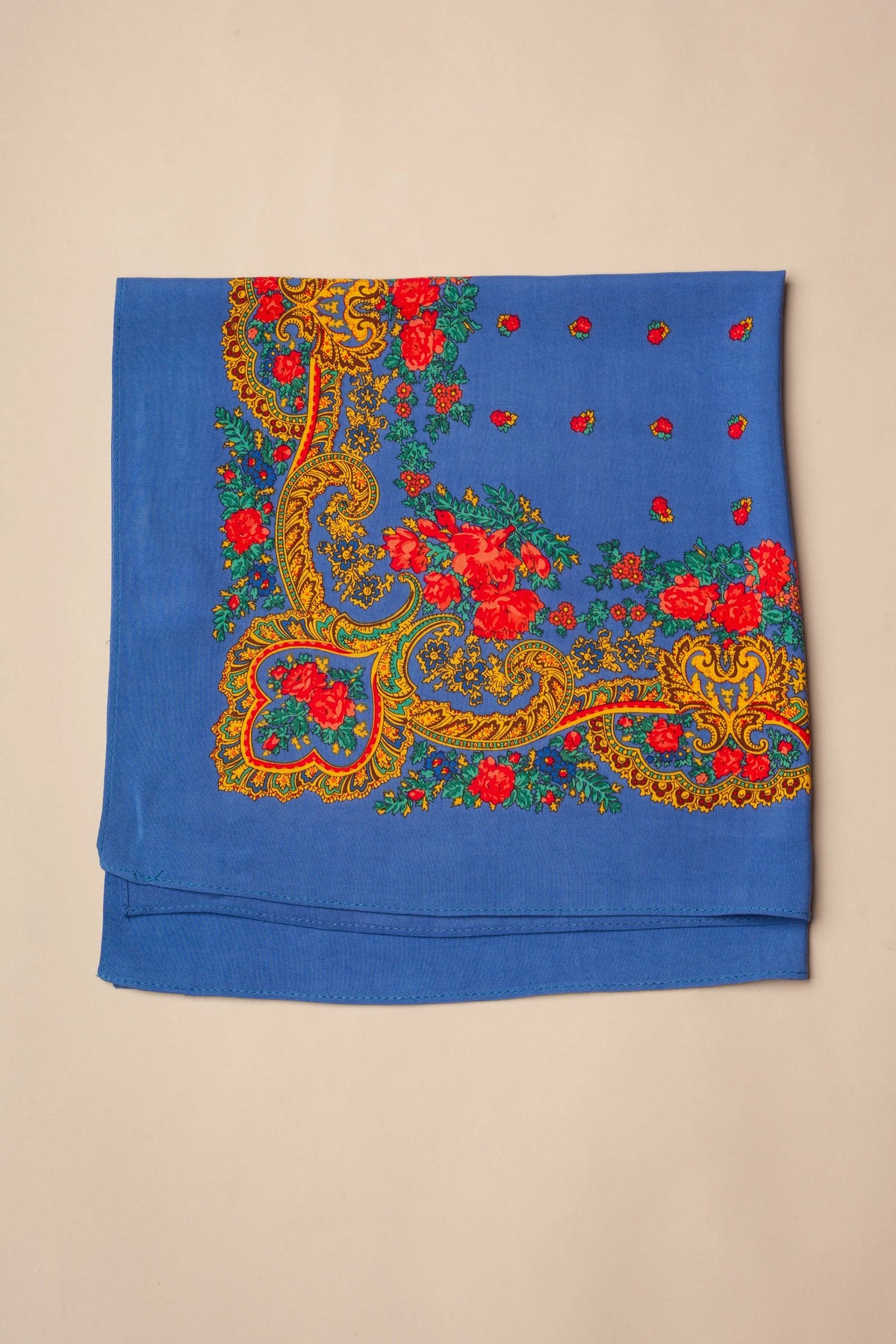 Blue Portuguese headscarf with ornate yellow chain patterns and vibrant red rose floral accents.