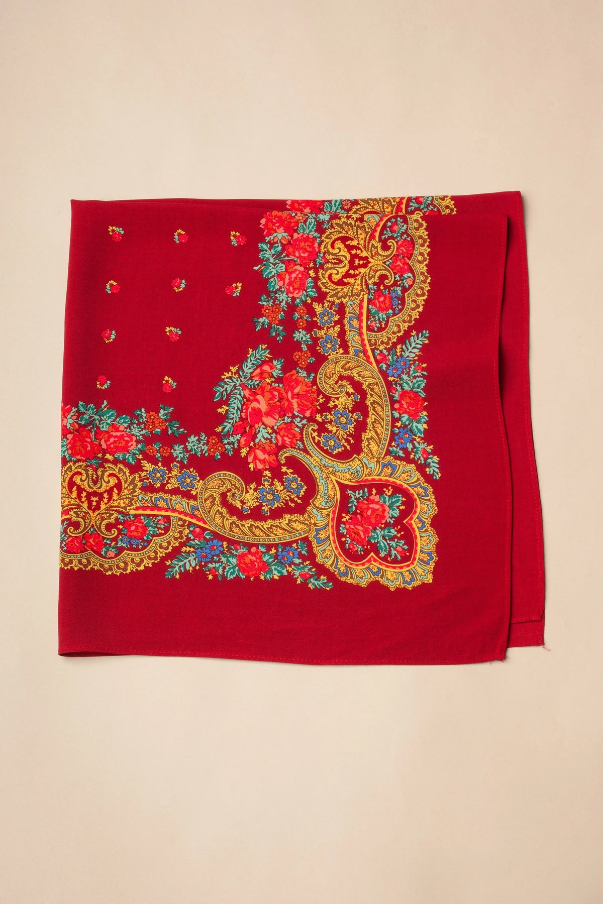 Square maroon scarf with traditional floral print, gold chain-like flourishes, and delicate blue and red detailing.