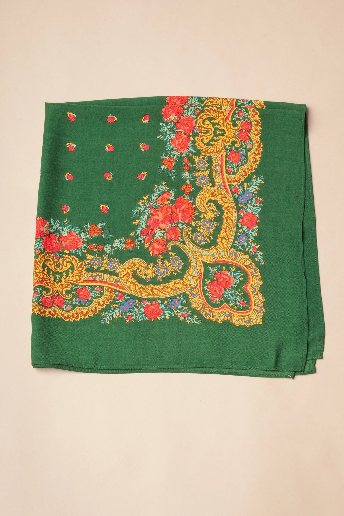 Bottle green square scarf with ornate gold chain patterns and vibrant red floral borders on a beige background.